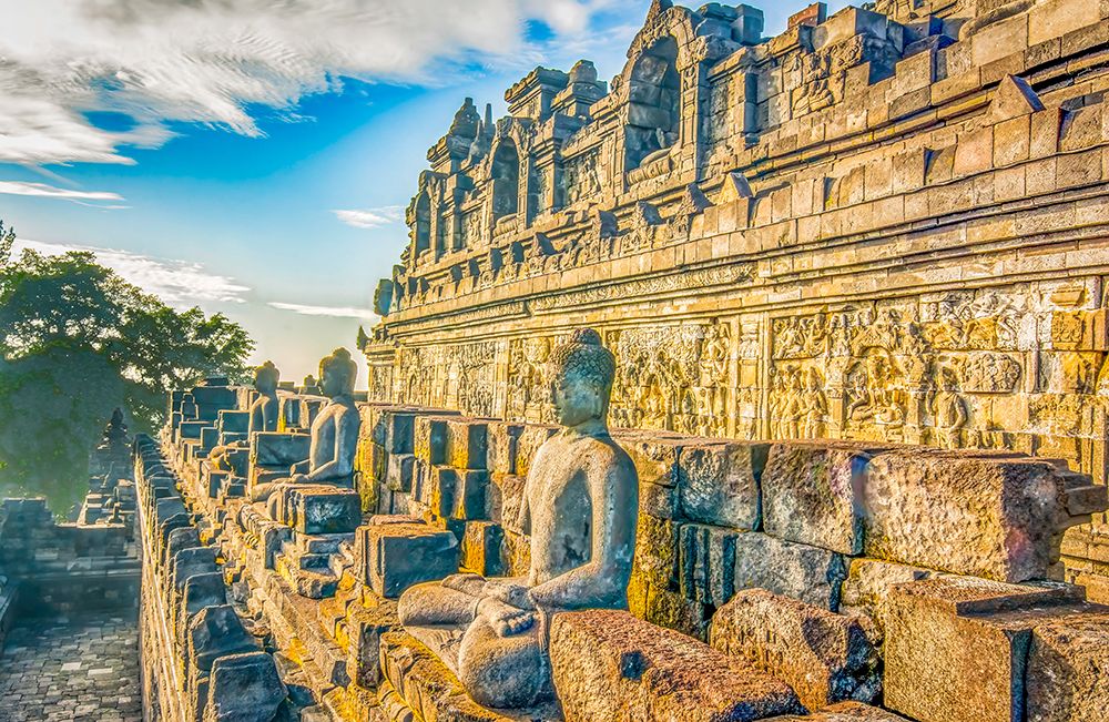 Java, Indonesia. Some of the original 504 statues of Buddha on a ledge of Borobudur Temple.
